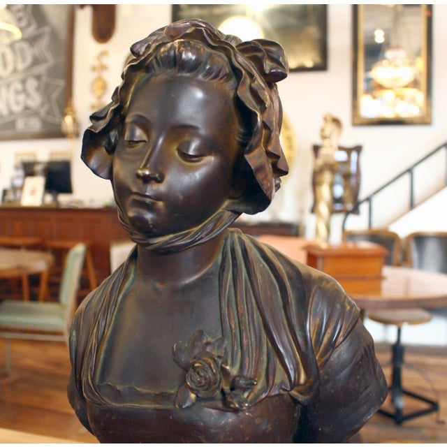 Elegant bronze bust statue of a woman wearing a bonnet. This piece is signed by E. Laurent 1832-1898. The dimensions are...