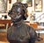 Elegant bronze bust statue of a woman wearing a bonnet. This piece is signed by E. Laurent 1832-1898. The dimensions are...