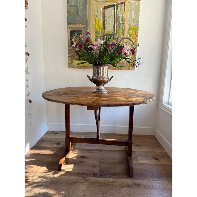 This French Provincial antique vintner's table dates from the 19th century. The wood has a beautifully aged light to...