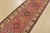 A tribal Caucasian Kazak runner hand-knotted with fine wool on a cotton foundation. This rug features a row of medallions...