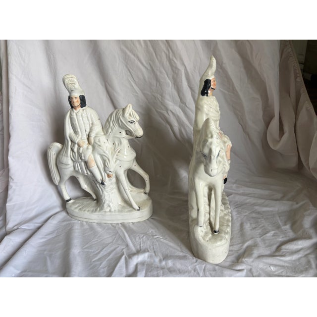 An early 19th C pair of Staffordshire figurines depicting two Scottish Hunters on horseback. This pair of Scottish hunters...