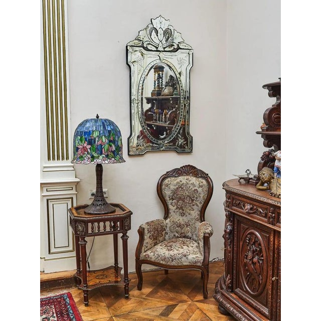 Elegant Venetian mirror decorated with hand engraving, grinding and faceted elements. The frame is decorated with a rich...