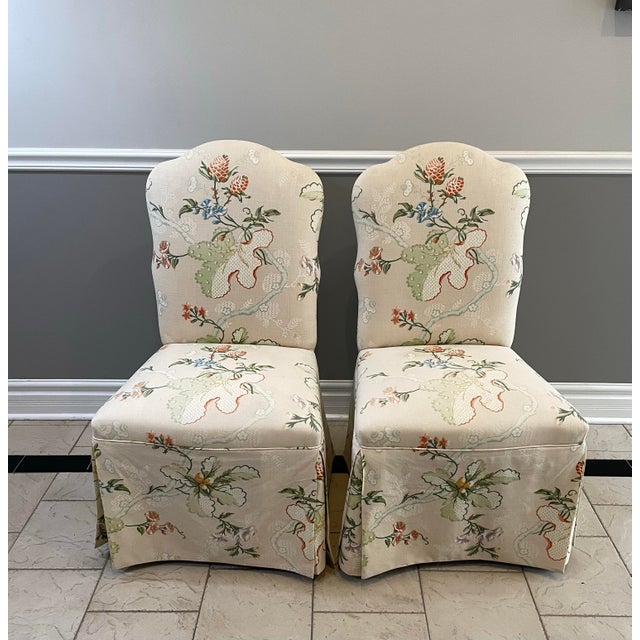 A beautifully tailored pair of skirted dining host chairs upholstered in Brunschwig & Fils “Fabriano,” a 1996 designer...