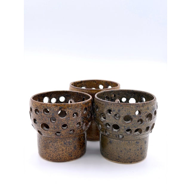 A rare set of three handcrafted stoneware candle holders designed by Finnish ceramic artist Pentti Envala for Studio...
