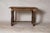 Crafted from solid wood, the table features a subtly shaped top adorned with a geometric veneer that highlights the...