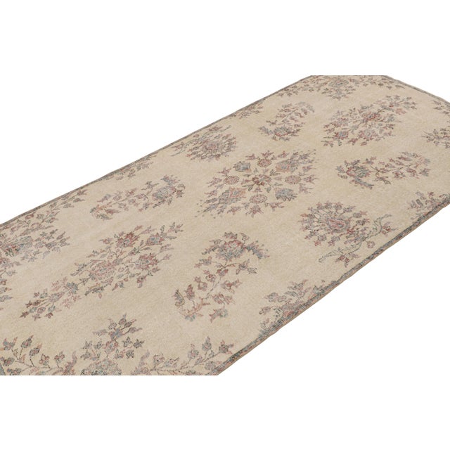 Hand Knotted in wool, this 4x9 vintage Zeki Múren rug originating from Turkey, circa 1960-1970, features a unique play of...