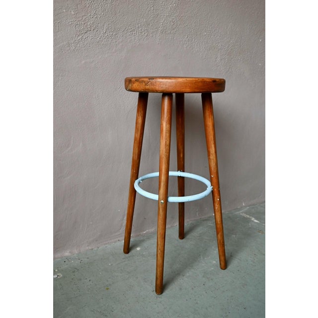 Full of character, this bar stool exudes the joyful spirit of the 1960s. Its round, solid wood seat rests on four slightly...