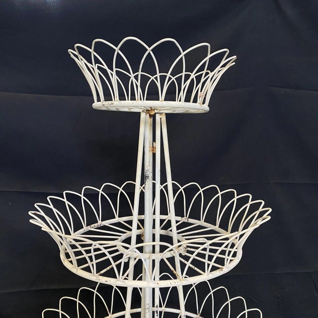 Lovely French three tier vintage iron and wire plant stand having a round form. The three tier frame is decorated with...