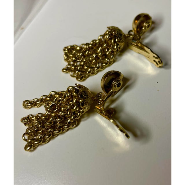 This is part of Chairish’s Costume Jewelry assortment. Gold Tassel Earrings w 1940s rivet construction and clip-ons.