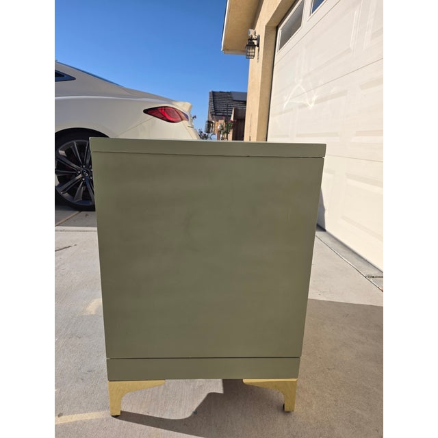 24H by 24W by 22D (inches) Beautifully refinished nightstand featuring a soft sage green finish paired with elegant gold...