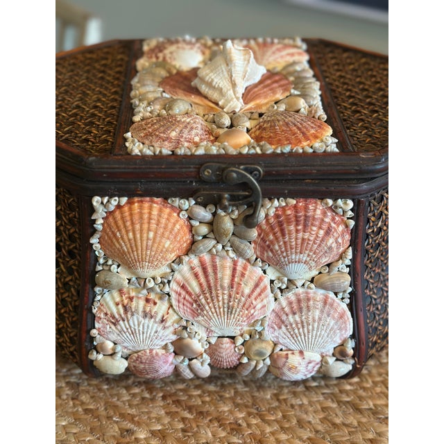 A charming vintage woven rattan basket or sewing box, beautifully embellished with an intricate collection of natural...