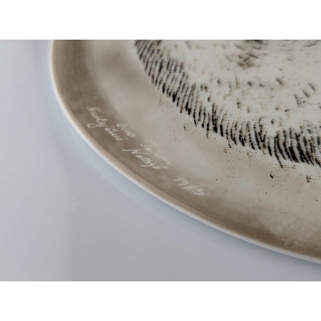 This decorative plate was designed by Oiva Toikka in 1983 and manufactured at the Nuutajärvi Factory in Finland. It is a...