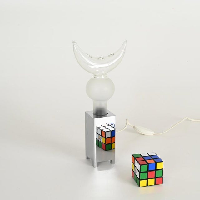 Stylish pair of mid-century italian table lamps in chromed metal and murano blown glass. These charming and unique lamps...