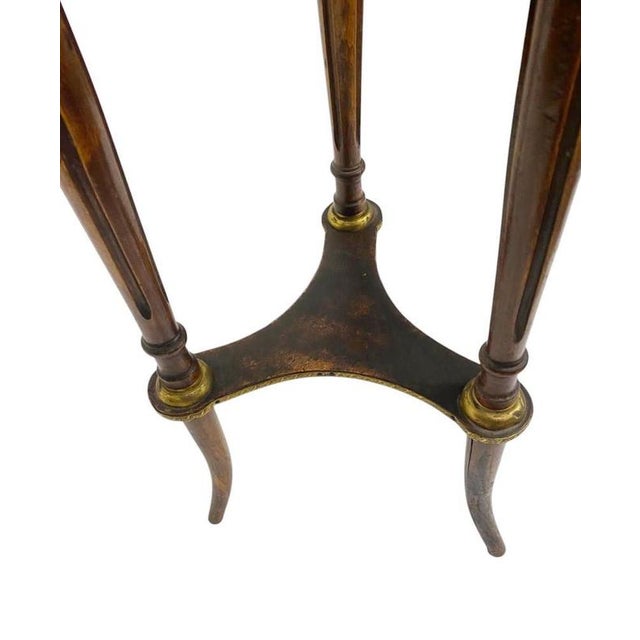 An elegant French Louis XVI Revival pedestal table, dating to the late 19th century, crafted in richly figured mahogany...