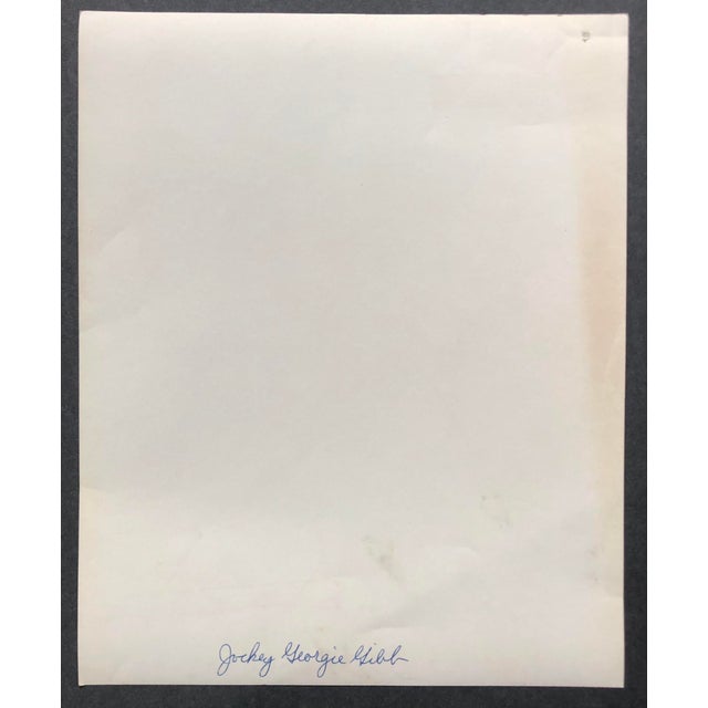 1950s black and white horse racing photograph of jockey Georgie Gibb (1935-1969) dressed in his racing silks for a race....