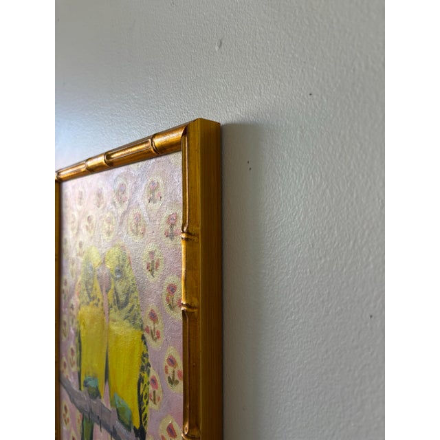 An original painting by Michelle Heimann of a pair of yellow budgies perched together on a branch with pink flower pattern...