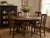 A handsome set of four antique American oak dining chairs featuring shaped splat backs, solid oak construction, gracefully...