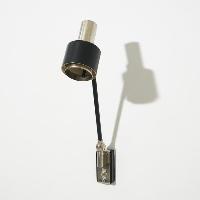 Wall lamp produced by Stilnovo in the 1960s, defined by a clean and functional design typical of Italian production of the...