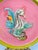This delightful set of plates features a whimsical and highly decorative coastal motif, showcasing a raised relief...