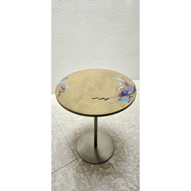 Carlo Malnati painterly wood table in a matte metallic gold. A rainbow of colors produce a beautiful abstract design. It...