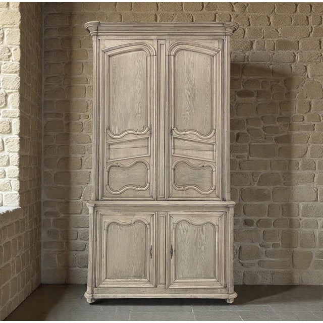 Rooted in the refined traditions of the French countryside, this grand 18th century buffet à deux corps reflects the quiet...