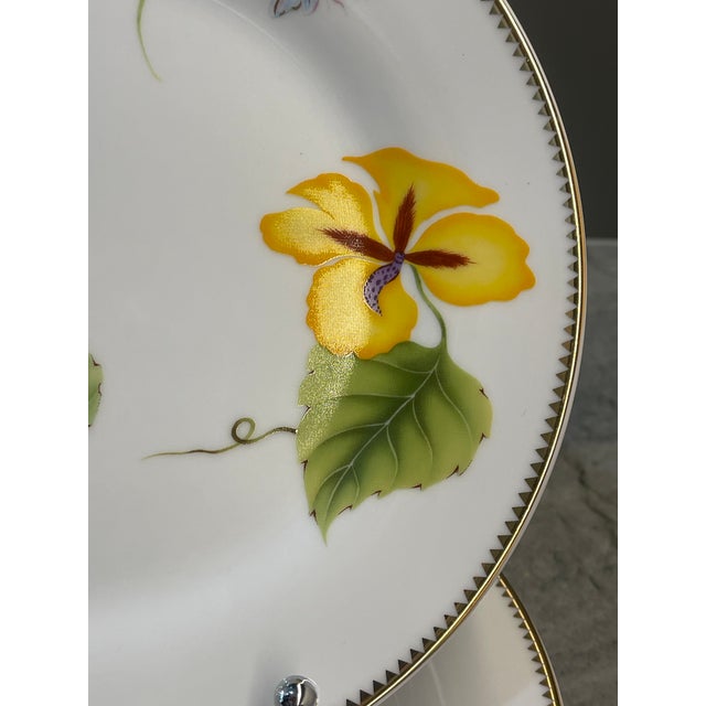 A beautiful set of four Godinger & Co. Tivoli plates featuring a vibrant botanical motif accented with elegant gold trim....