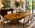 A beautifully crafted vintage Mastercraft dining table showcasing stunning book-matched olive ash burl veneer and the...