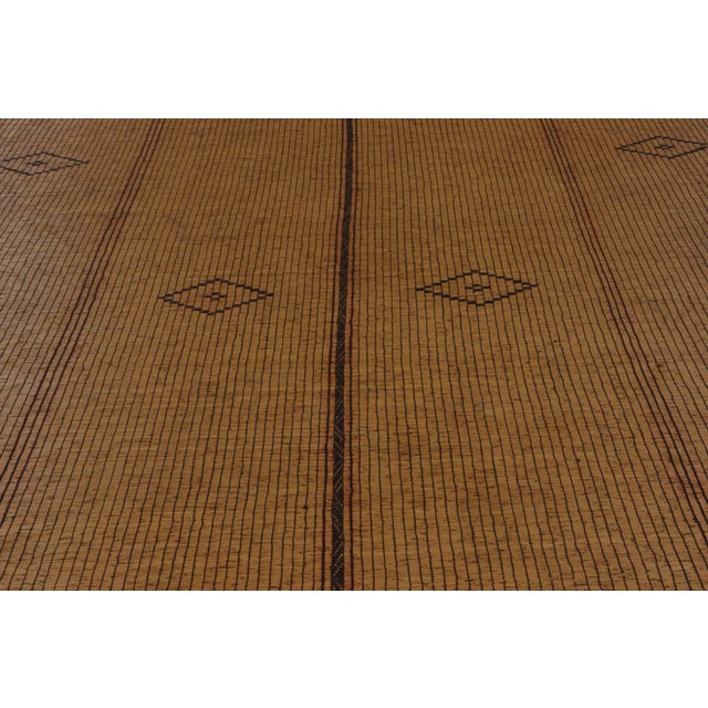 Made with handwoven reed and camel leather in Mauritania circa 1950-1960, this 8x18 vintage Tuarage runner mat is an...