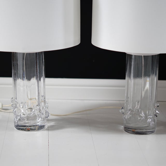 Beautiful glass lamps by Kosta Sweden, Sweden, 1960s. Designed by Ove Sandberg. The base of the lamp is decorated with...