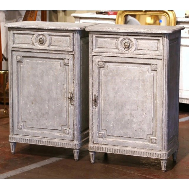 Elegant in their tall, narrow proportions, this handsome pair of antique confiturier cabinets combines restrained Louis...