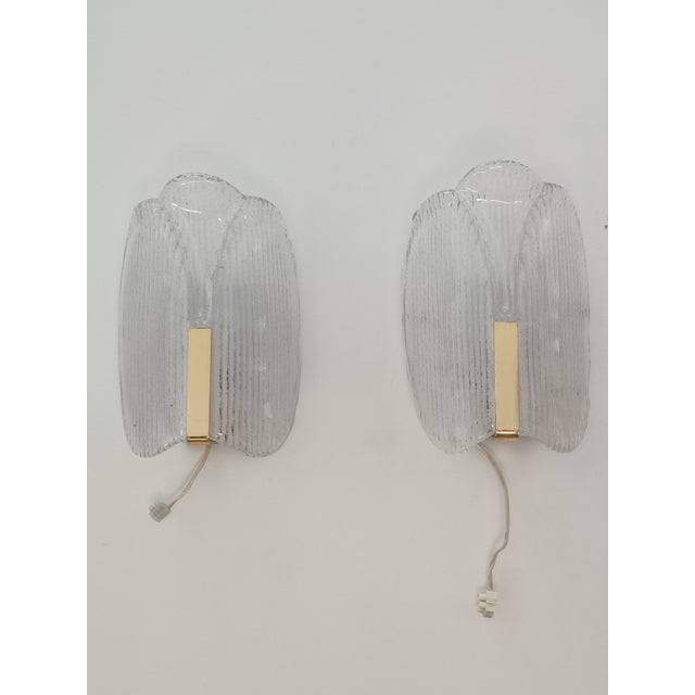 Magnificent pair of wall sconces by carl fagerlund for orrefors. sweden, 1970s. brass structure supporting a sublime...