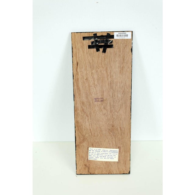 A little boy who just received a penicillin shot. signed on back with studio stamp. along with an old description label....