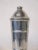 A very nice sized ribbed aluminum cocktail shaker with cone top , built in strainer and pour cap . Manufactured by the...