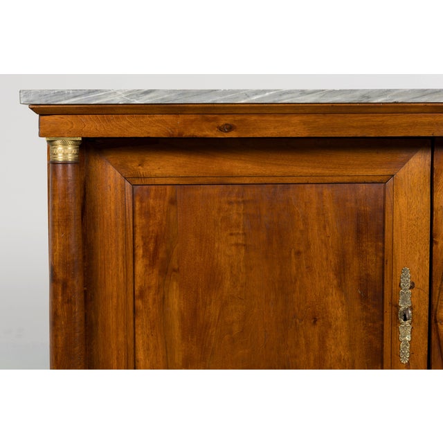 Sourced in Provence, France, this early 19th century French Empire buffet is crafted from solid walnut and retains its...
