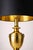 Vintage Hollywood Regency polished brass urn table lamp with original black shade featuring a gold-lined interior. Elegant...