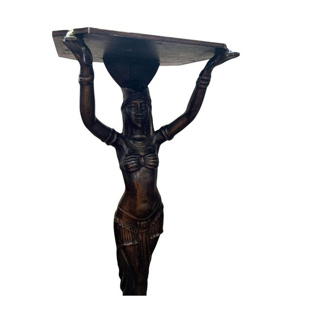 A striking circa 1920s cast iron table bases of female figures with raised arms in stylised Egyptian dress typical of Art...