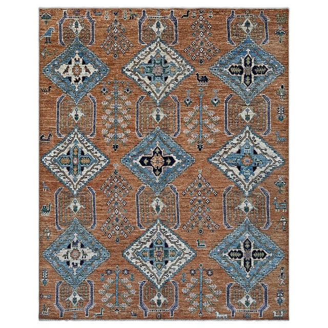 Nine latch-hooked diamond medallions in sky blue and ivory march in three stately columns down a warm cinnamon field, each...
