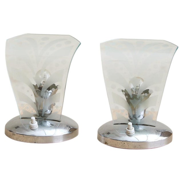 A petite Italian table lamp from the 1950s, defined by its etched Murano glass shade and polished chrome base. The curved...
