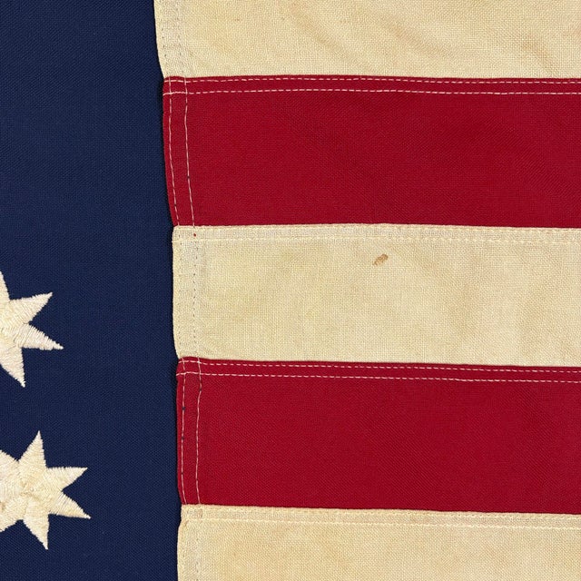 This vintage American Bennington flag is made from a cotton cloth, with fully embroidered emblem and sewn stripes. Please...