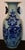 Chinese baluster turned vase, 19th century. Decorated with floral designs on a rock work platform. Blue slip painted...