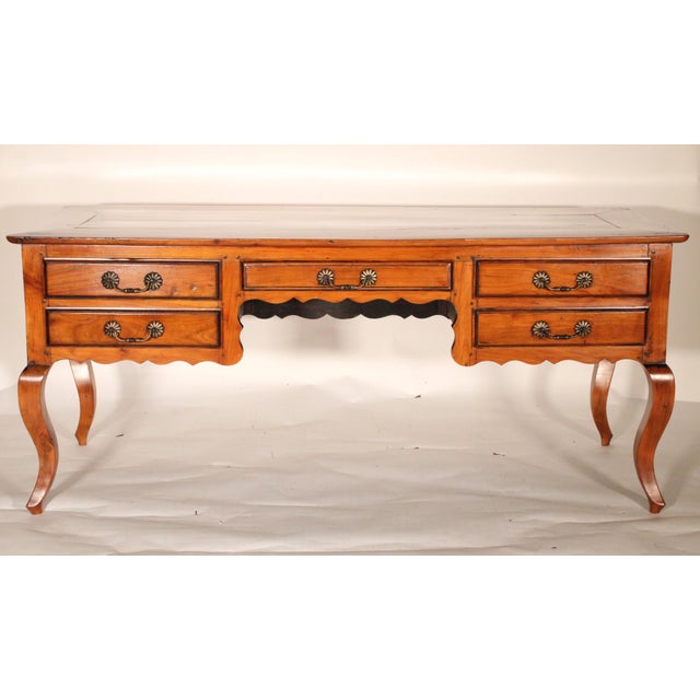 Louis XV provincial style fruitwood desk, 19th century. With a rectangular top with rounded corners, the front with a...