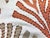 54" wide designer embroidered nautical coral cotton drapery fabric in orange, beige, ivory, and tan. Price is per yard.