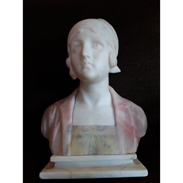 This is an antique Art Nouveau bust of a young woman on a white marble base signed on the back 'Dedina' This piece has an...