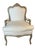 A pair of Louis XV-style upholstered Bergere armchairs with Rococo influence. These chairs with cabriole legs and a gently...