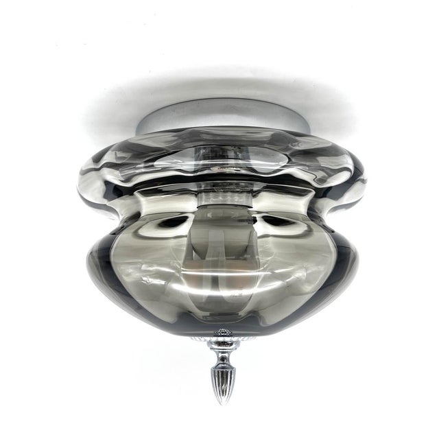 This sculptural ceiling light is an outstanding example of german lighting design from the 1970s, crafted by the renowned...