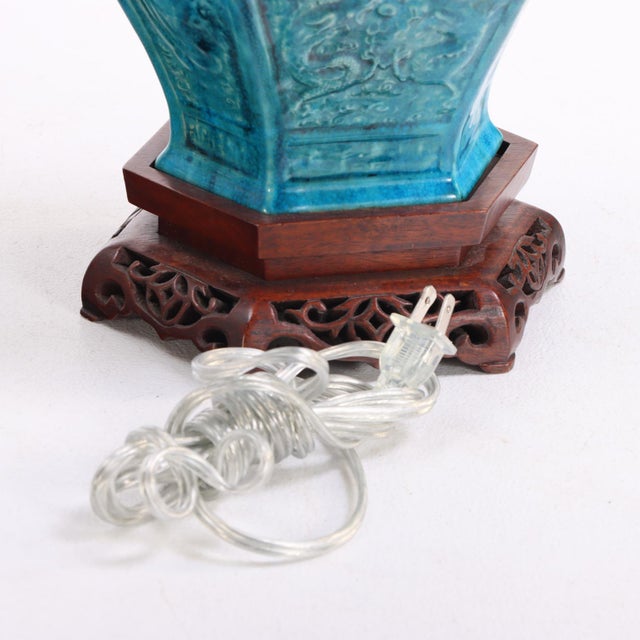 The 20th-century porcelain body of robust hexagonal baluster form, entirely covered in a vivid peacock-blue turquoise...
