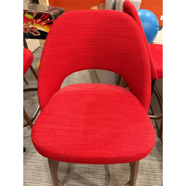 Upholstered in Knoll Classic Boucle in Crimson over a molded reinforced polyurethane back shell and contoured plywood...