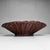 An exceptionally large Japanese basket bowl with a low, wide shape and beautifully rhythmic weaving in warm reddish-brown...