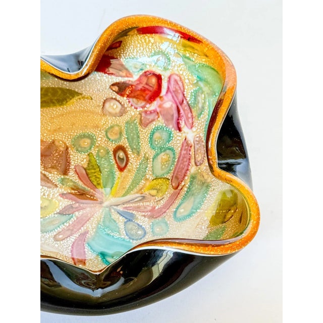 Sourced from an estate of a woman who traveled to Italy often, this stunning black, orange, and yellow Murano style blown...