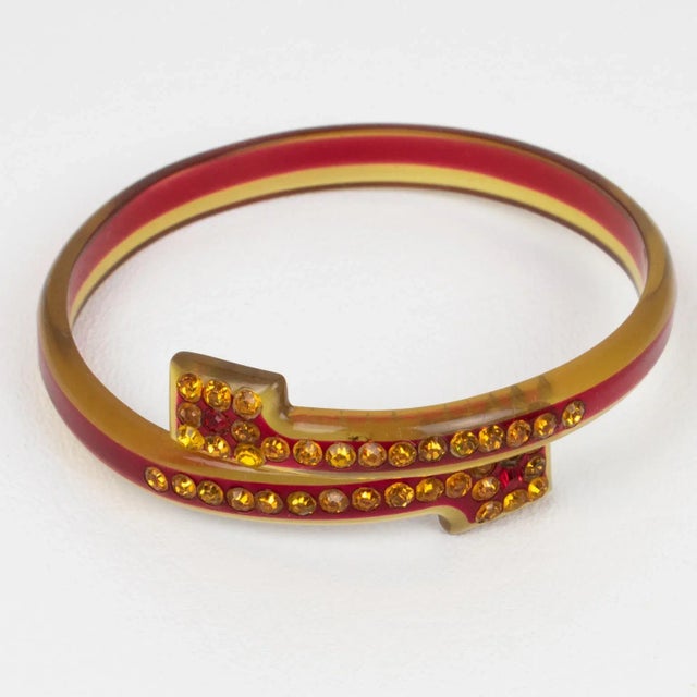 This stunning French celluloid and sparkle bypass bracelet bangle dates from the 1920s. The piece boasts transparent apple...